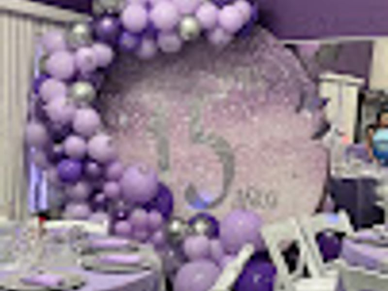 Purple themed baby shower with balloon arch