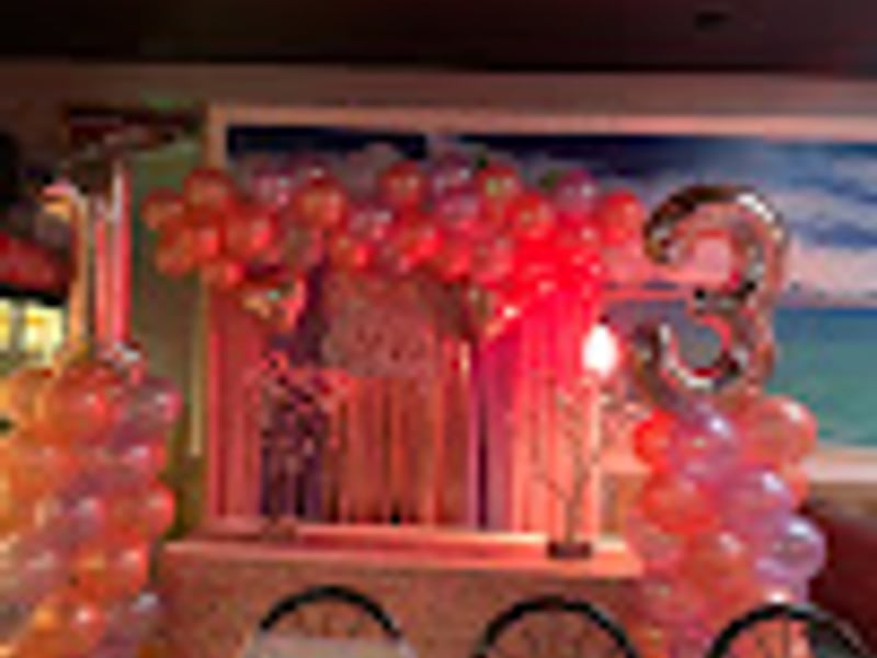 Red themed birthday party setup with elegant decorations