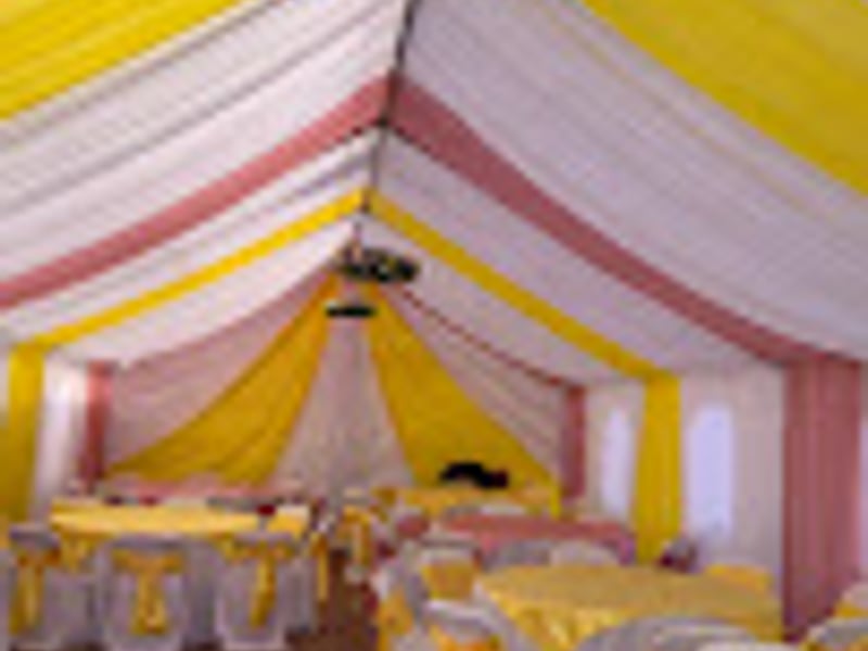 Corporate event tent with yellow and white decorations