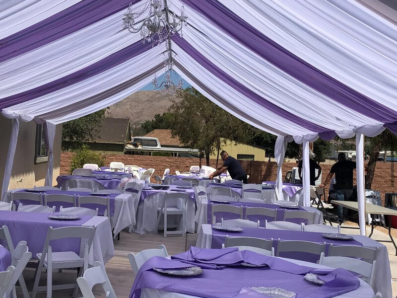 Elegant party event setup with tables, chairs and decorative elements