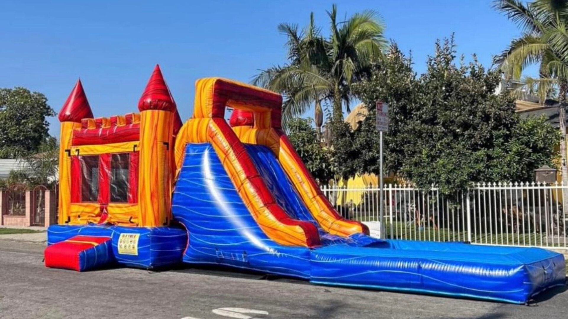 Vibrant party setup with colorful decorations and bounce house