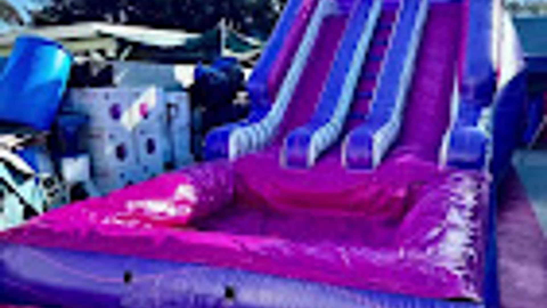 Vibrant party setup with colorful decorations and bounce house
